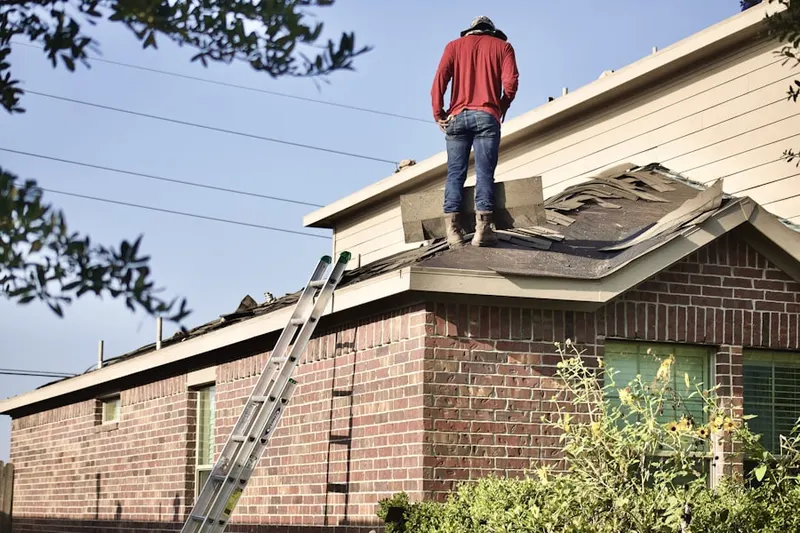 Professional roofer working on a residential roof in Bennington Place